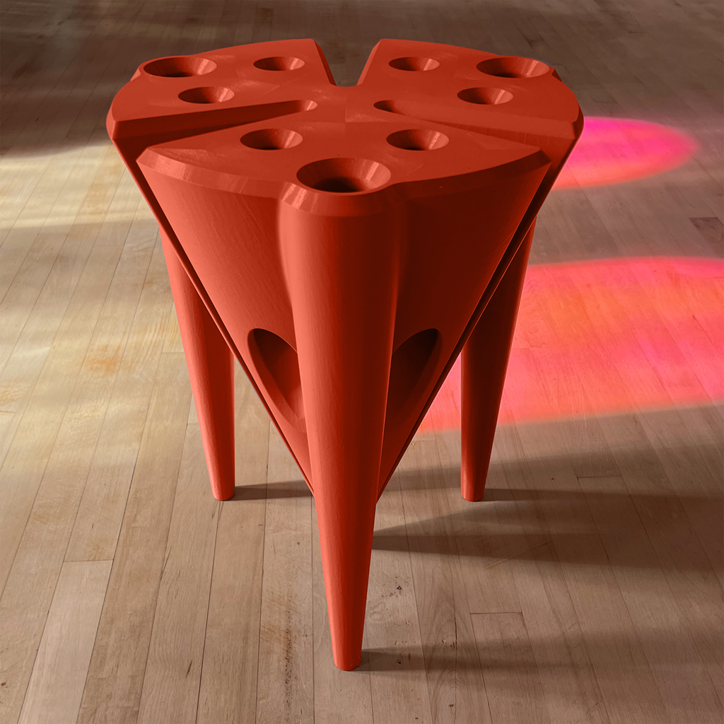 Red, modernist stool with unique design on a wooden floor
